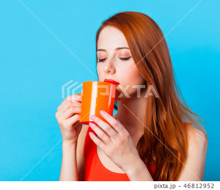 woman with cup on blue background. woman with cup on blue background. 46812952