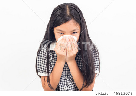 sick child girl blowing her nose isolated on white 46813673