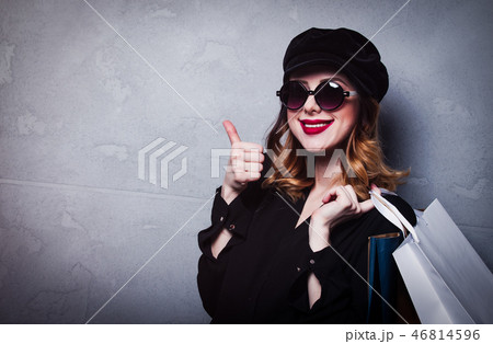 Style redhead girl in hat with shopping bags and sunglasses Style redhead girl in hat with shopping bags and sunglasses 46814596