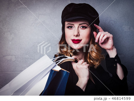 Style redhead girl in hat with shopping bags 46814599