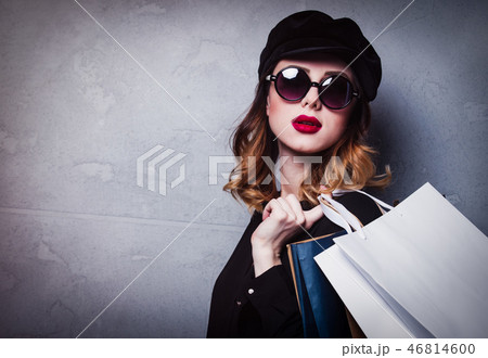 Style redhead girl in hat with shopping bags and sunglasses 46814600