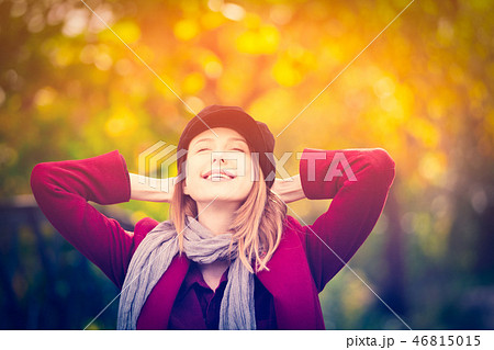 woman in red coat and hat have a rest in autum park 46815015