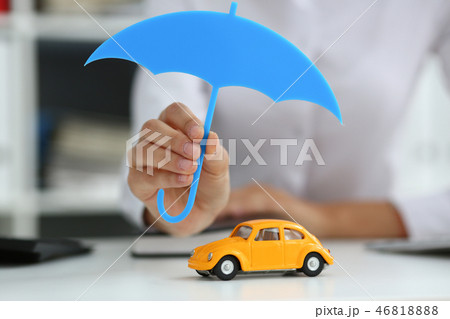 The female hand holds a miniature umbrella in the The female hand holds a miniature umbrella in the 46818888