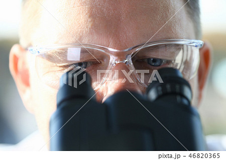 Male scientist looking through binocular 46820365
