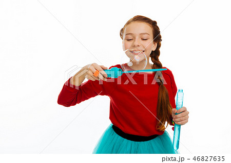 Joyful happy girl enjoying blowing soap bubbles 46827635