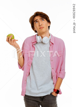 Nice thoughtful boy thinking about the apple Nice thoughtful boy thinking about the apple 46828942