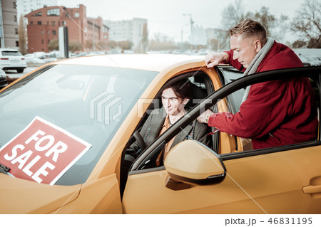 Student feeling excited while choosing new car with father 46831195