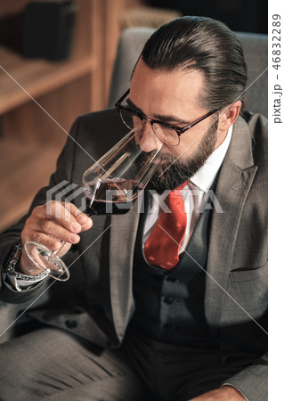 Top view of stylish mature businessman drinking some red wine Top view of stylish mature businessman drinking some red wine 46832289
