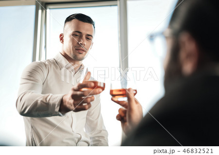 Two business partners drinking some cognac after successful negotiation Two business partners drinking some cognac after successful negotiation 46832521