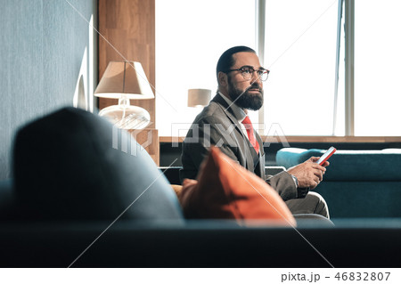 Businessman wearing glasses and red tie preparing for negotiation Businessman wearing glasses and red tie preparing for negotiation 46832807