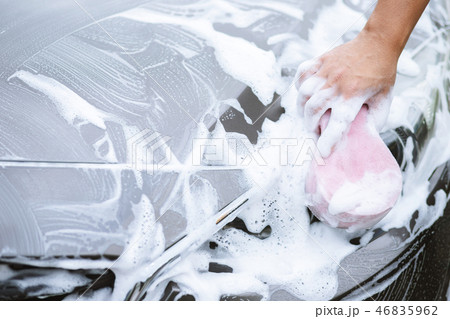 The man hand with pink sponge clean washing car The man hand with pink sponge clean washing car 46835962