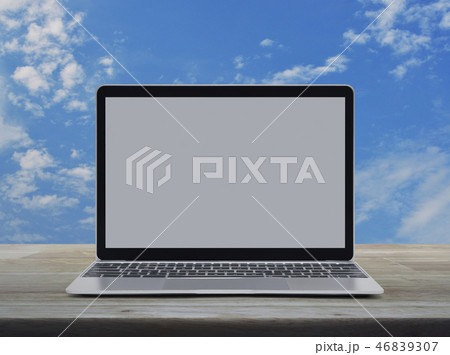 Laptop computer with blank screen on table 46839307