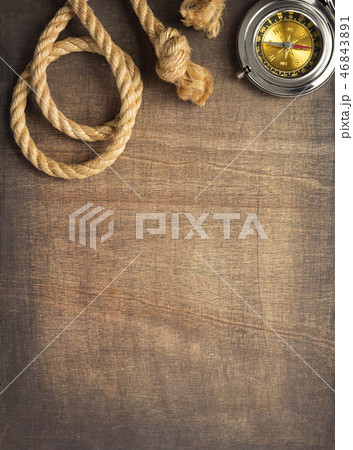 ship compass and rope at wooden background 46843891