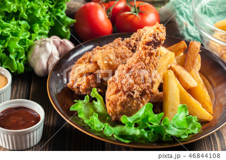 Fried kentucky chicken legs with french fries Fried kentucky chicken legs with french fries 46844108