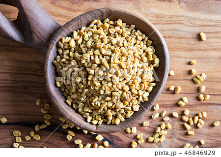 Fenugreek seeds on a wooden spoon, top view 46846929
