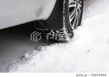 Close up of a cars tires on a snowy road Close up of a cars tires on a snowy road 46850698