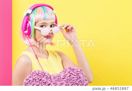 Woman in a wig holding a big heart Woman in a wig holding a big heart 46852897