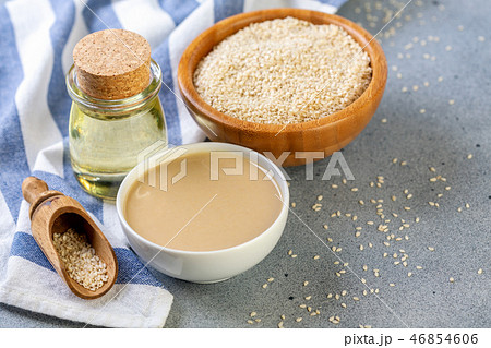 Bottled sesame oil, tahini and white sesame seeds. Bottled sesame oil, tahini and white sesame seeds. 46854606
