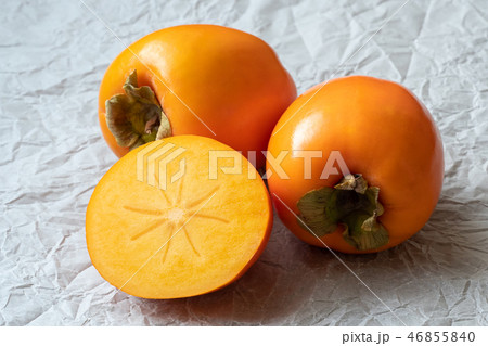 Whole and half of fresh ripe persimmons.  46855840