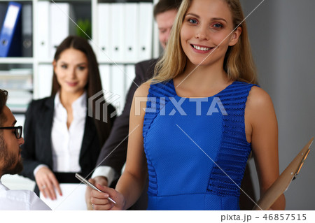 Beautiful smiling clerk girl wearing blue sundress Beautiful smiling clerk girl wearing blue sundress 46857515