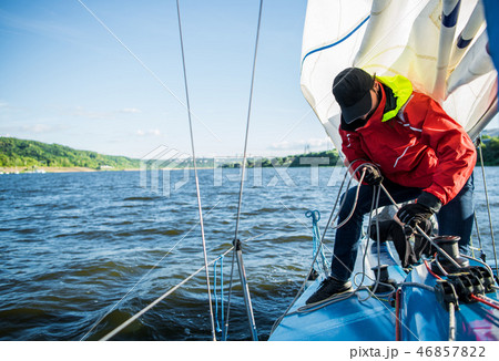 Young man working on sailing ship, active lifestyle, summer sport concept Young man working on sailing ship, active lifestyle, summer sport concept 46857822
