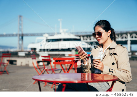 woman sitting on street cafe outdoor near port 46862548