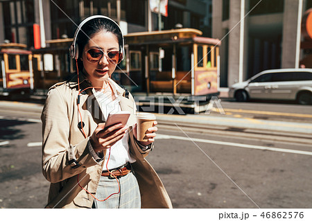 Happy teenager listening music wearing headphones 46862576