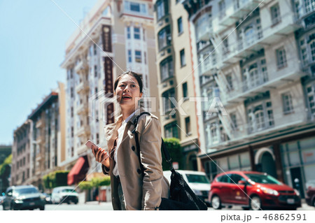 lady traveler holding cellphone carry backpack lady traveler holding cellphone carry backpack 46862591
