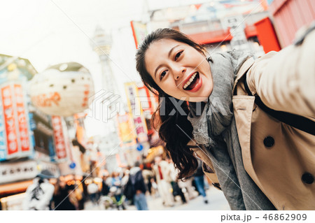 traveler cheerfully taking selfie in tsutenkaku 46862909