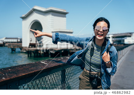 lady standing on the harbor excited pointing sea lady standing on the harbor excited pointing sea 46862982