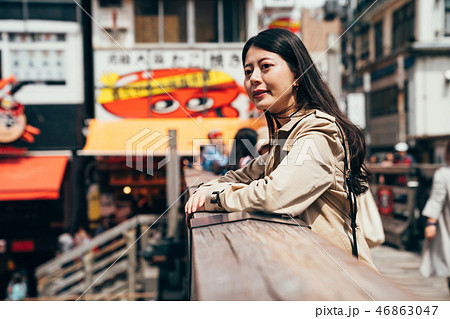 young lady standing above the canal in dotonbori young lady standing above the canal in dotonbori 46863047