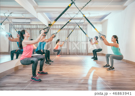 asian people doing squat with fitness straps 46863941