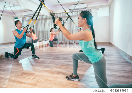 young people are training indoors with TRX 46863942