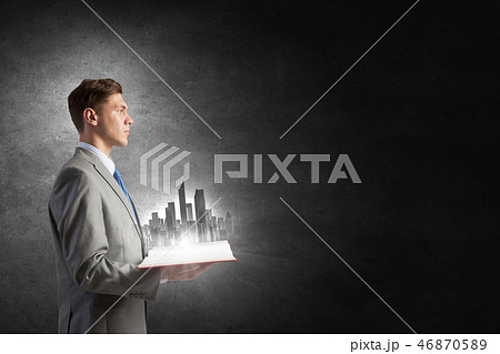 Businessman with book in hands Businessman with book in hands 46870589
