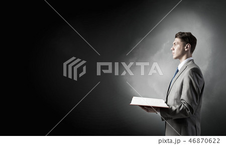 Businessman with opened book Businessman with opened book 46870622