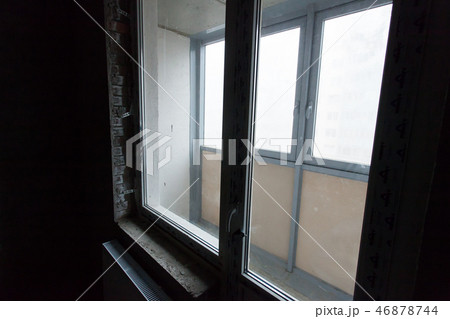 Unfinished building interior, gray room. Repairs in the apartment. Preparing in the room Unfinished building interior, gray room. Repairs in the apartment. Preparing in the room 46878744