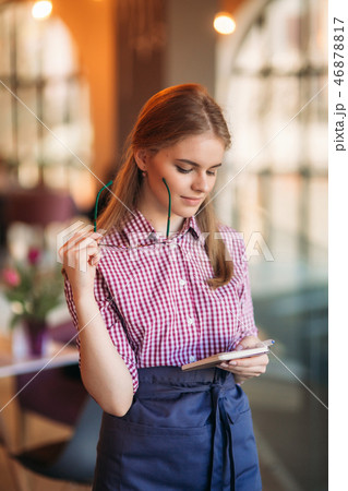 Portrait of a beautiful friendly waitress in glasses with notepapers and pen ready to take your Portrait of a beautiful friendly waitress in glasses with notepapers and pen ready to take your 46878817