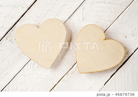 Two wood heart on a vintage wooden background. Two wood heart on a vintage wooden background. 46879736