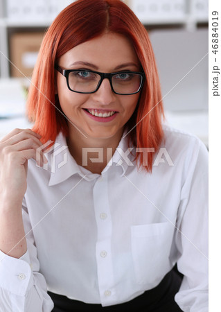 Red haired business woman with glasses 46884019