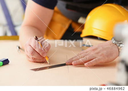 Arms of worker making structure plan 46884962