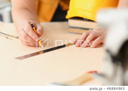 Arms of worker making structure plan 46884963