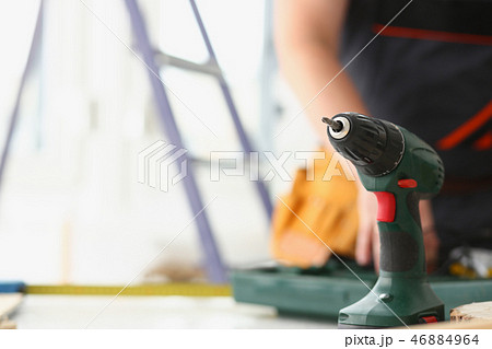 Arms of worker using electric drill Arms of worker using electric drill 46884964