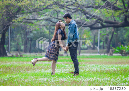 young asian couple in love  looking to each other 46887280