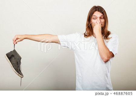 Man with stinky shoe Man with stinky shoe 46887605