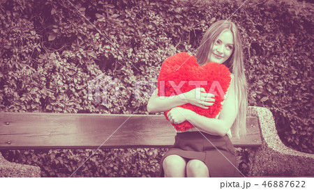 Enamored woman with big red heart Enamored woman with big red heart 46887622