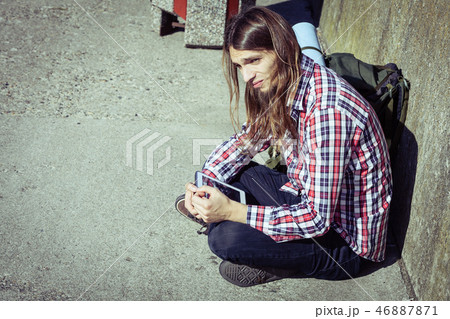 Man tourist backpacker sitting with tablet outdoor 46887871