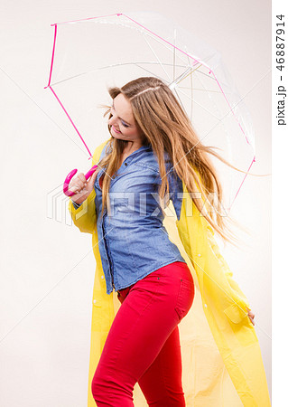 Woman wearing waterproof coat under umbrella Woman wearing waterproof coat under umbrella 46887914