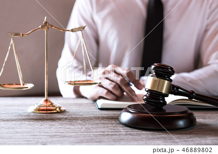 Gavel on wooden table and Lawyer or Judge working with agreement Gavel on wooden table and Lawyer or Judge working with agreement 46889802