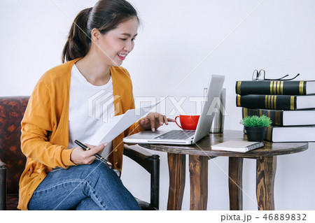 Happy casual young asian woman working in home or small office w 46889832
