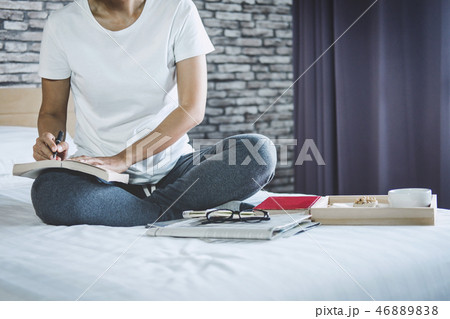 Young woman happiness on bedroom in enjoying reading books, news 46889838